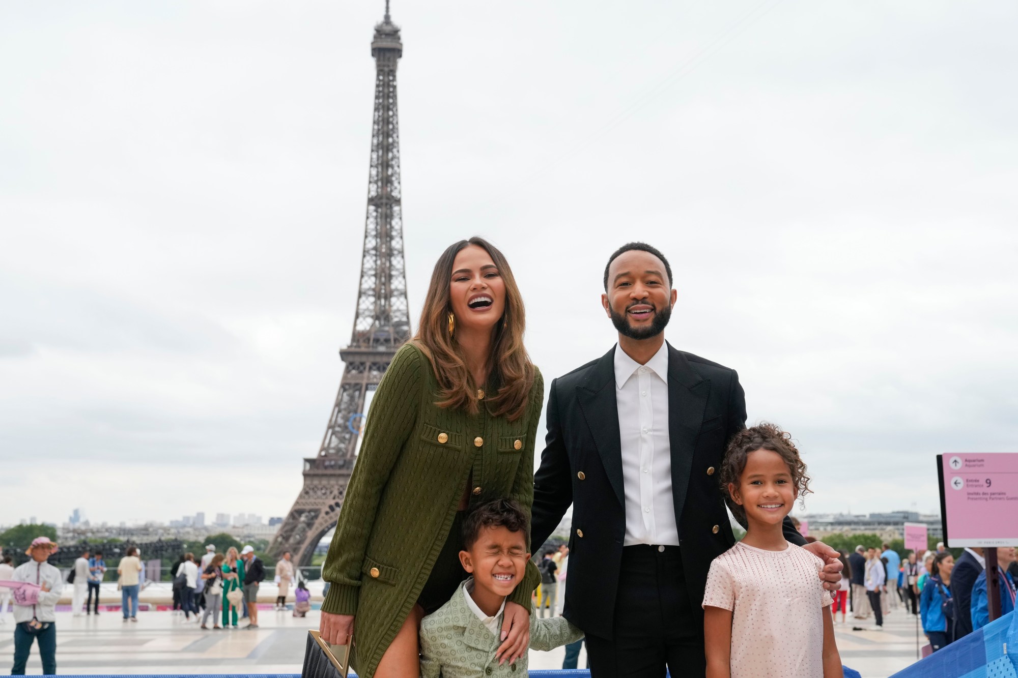 Chrissy Teigen and John Legend arrive with their children, Miles, foreground left and Luna in Paris, France, before the opening ceremony of the 2024 Summer Olympics, Friday, July 26, 2024. (AP Photo/Natacha Pisarenko)